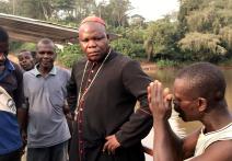 African men having discussion with the cardinal.